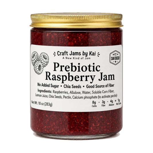 A 10 oz glass jar of Craft Jams by Kai Prebiotic Raspberry Jam with a gold metal lid and a white label, shown on a plain white background.